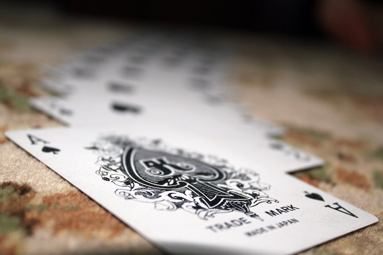 our-experience Close-up of Ace of Spades with a deck of playing cards, showcasing depth of field.
