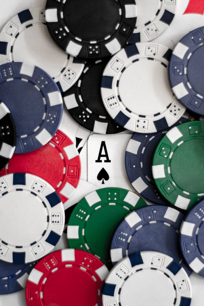ours-journey Close-up of poker chips with an ace of spades card, perfect for casino themes.